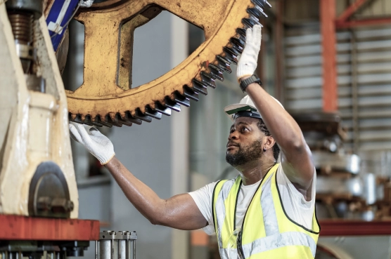 Connected hydration 4 Factory worker inspecting large industrial gear
