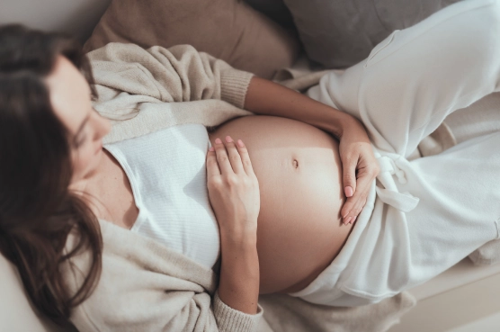 Research 14 Pregnant woman resting and holding her belly